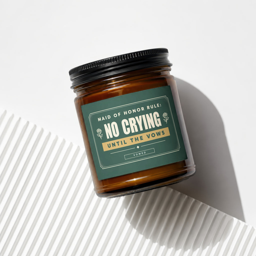 Amber glass candle with "Maid of Honor Rule: No Crying Until the Vows" text.