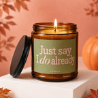 Amber jar candle with lit wick and text "Just say I do already".
