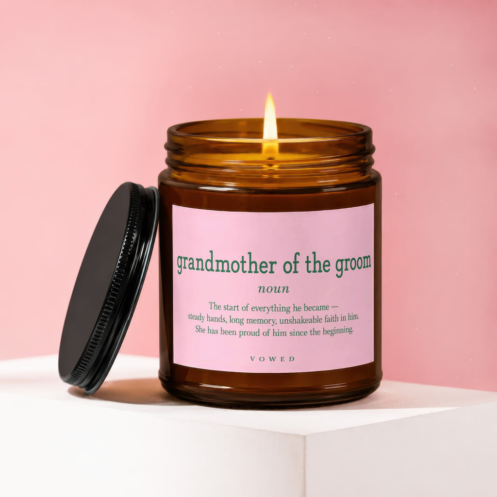Amber candle with pink label reading "grandmother of the groom" definition.