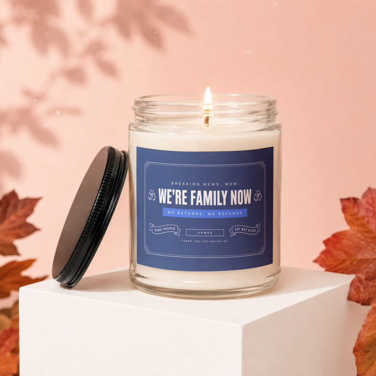 Candle with "We're family now" text, no returns, no refunds.