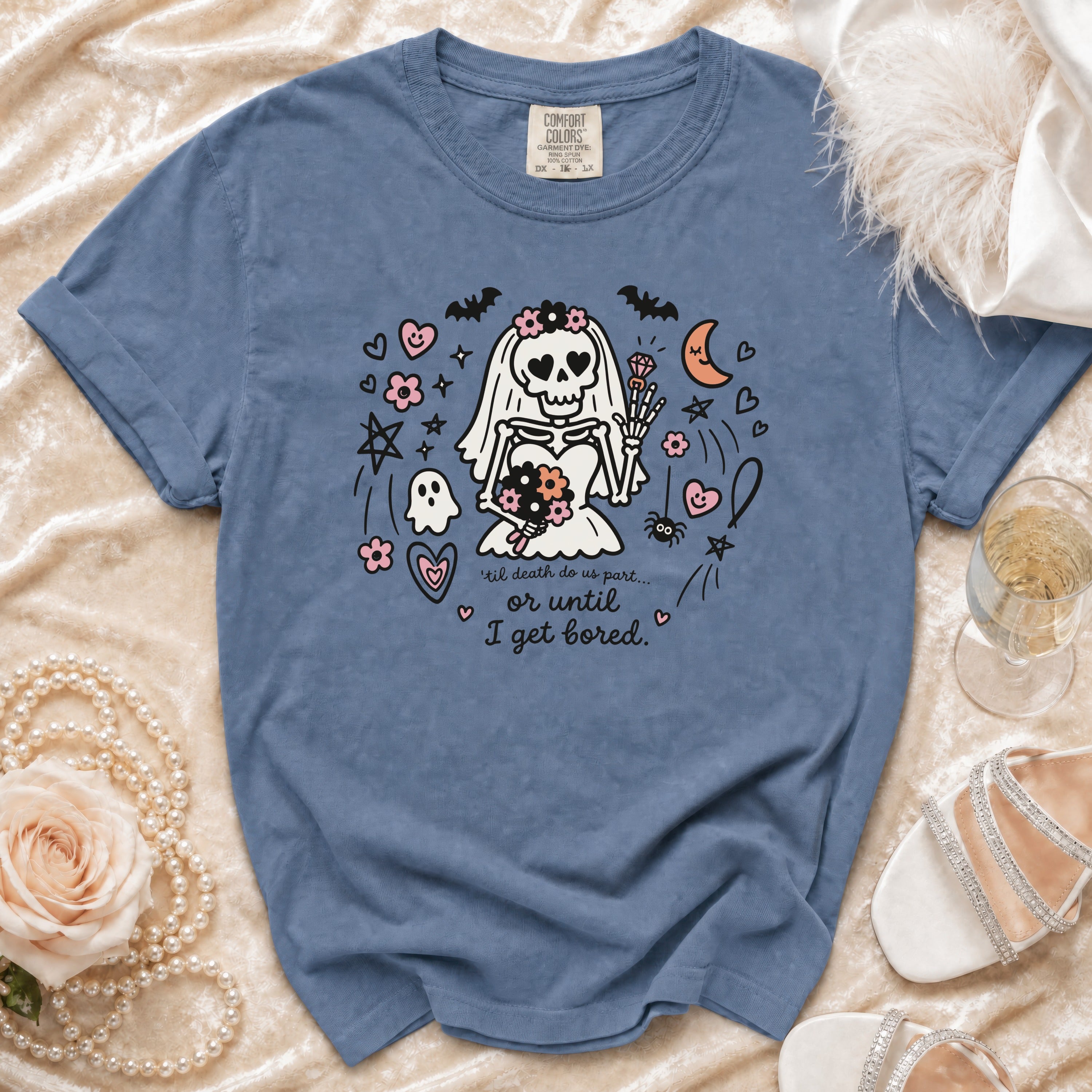 A blue t-shirt featuring a graphic of a skeleton bride with text that reads til death do us part or until I get bored.
