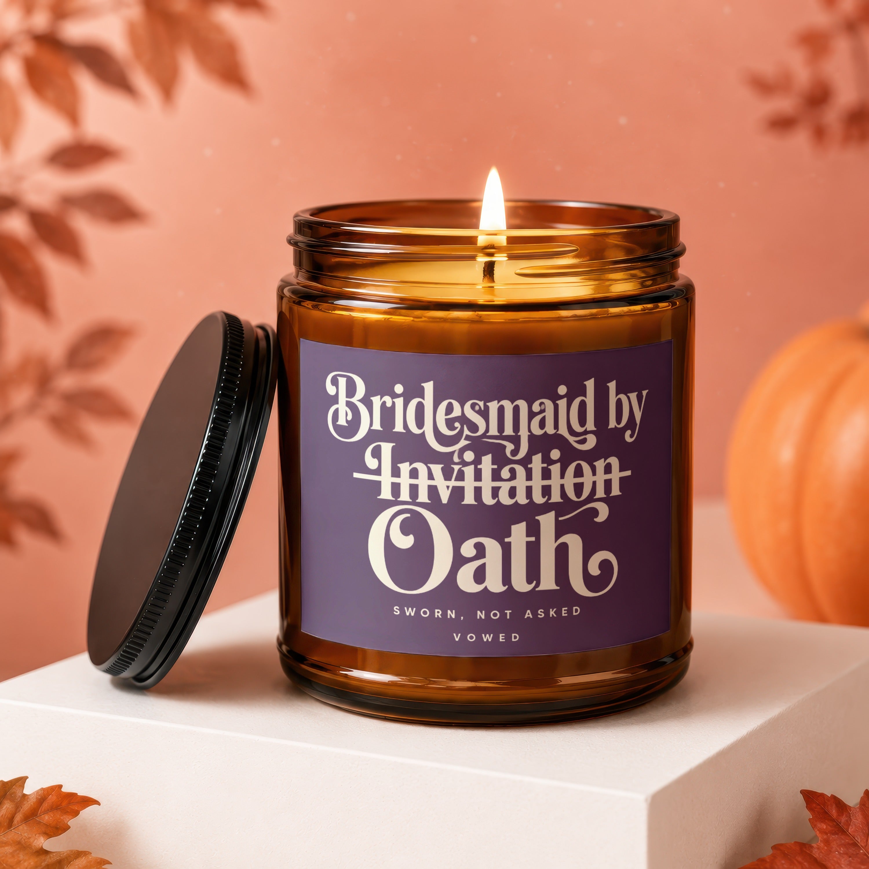 Amber glass candle with "Bridesmaid by Invitation Oath" label and lit wick.