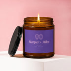 Amber glass candle with lit wick and purple label reading "Harper + Miles TOI ET MOI VOWED".