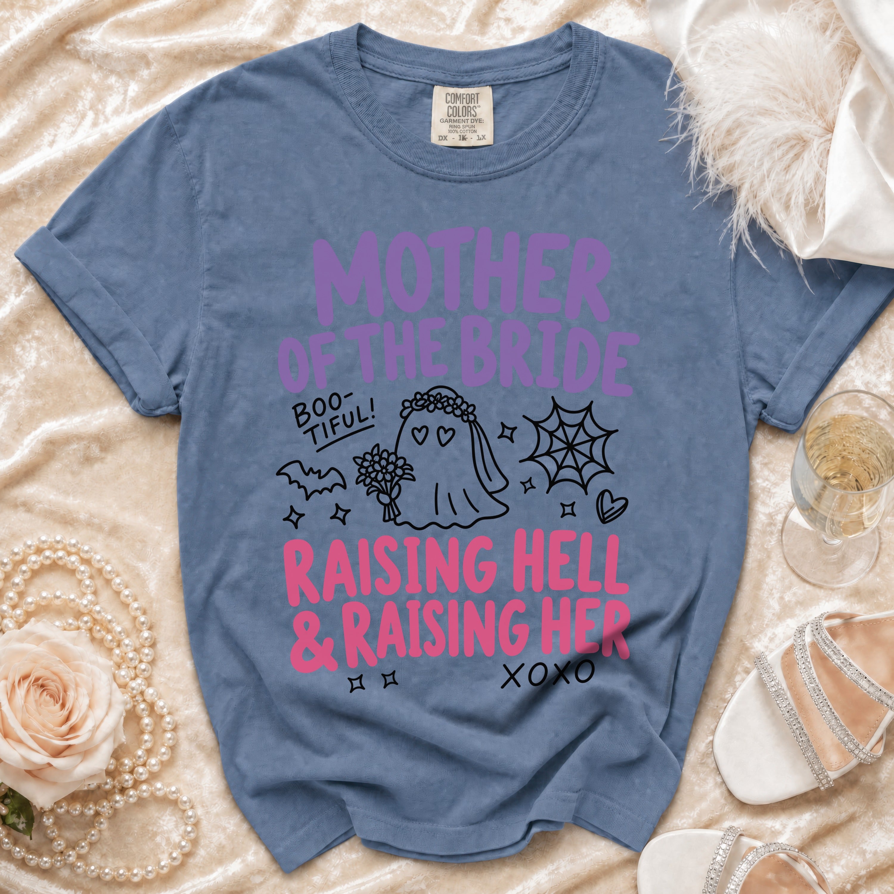 Blue shirt with "Mother of the Bride," "Boo-TIFUL!", and "Raising Hell & Raising Her" text.