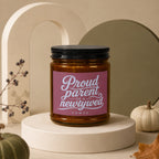 Candle labeled "Proud parent of a newlywed vowed" with decorative elements.