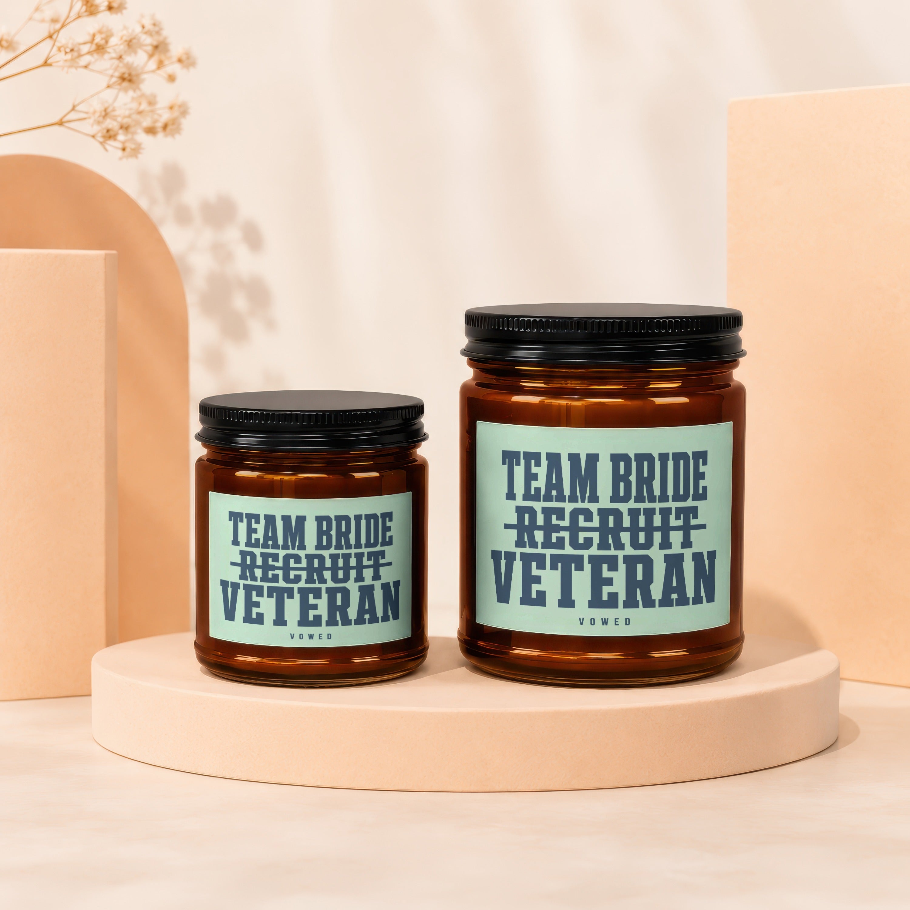 Two amber glass jars with black lids, featuring "TEAM BRIDE RECRUIT VETERAN" text on labels.