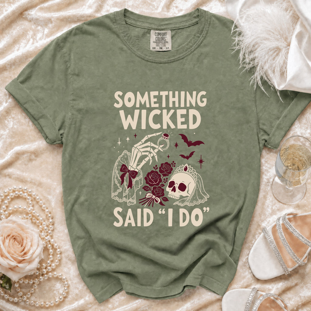 Olive green t-shirt with "Something Wicked Said 'I Do'" graphic featuring a skeleton hand and skull.