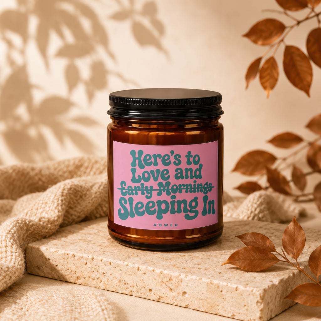 Candle with text Here's to Love and Early Mornings Sleeping In.