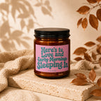Candle with text Here's to Love and Early Mornings Sleeping In.