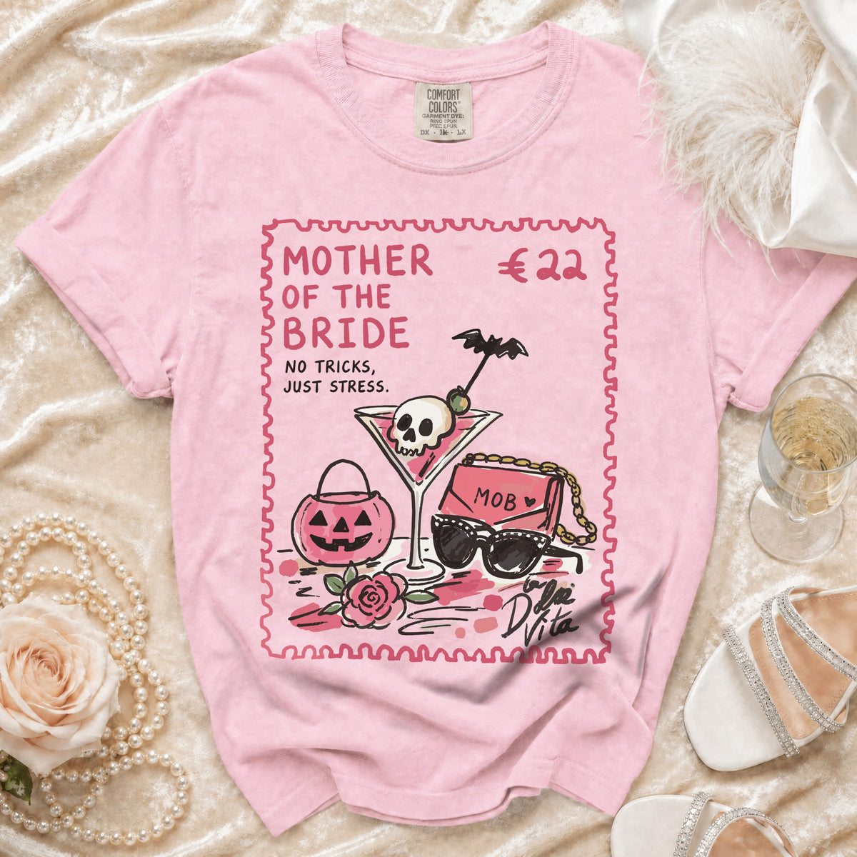 Pink t-shirt with "MOTHER OF THE BRIDE NO TRICKS, JUST STRESS." graphic.