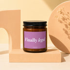 Brown glass candle with "Finally legal" text on a purple label.