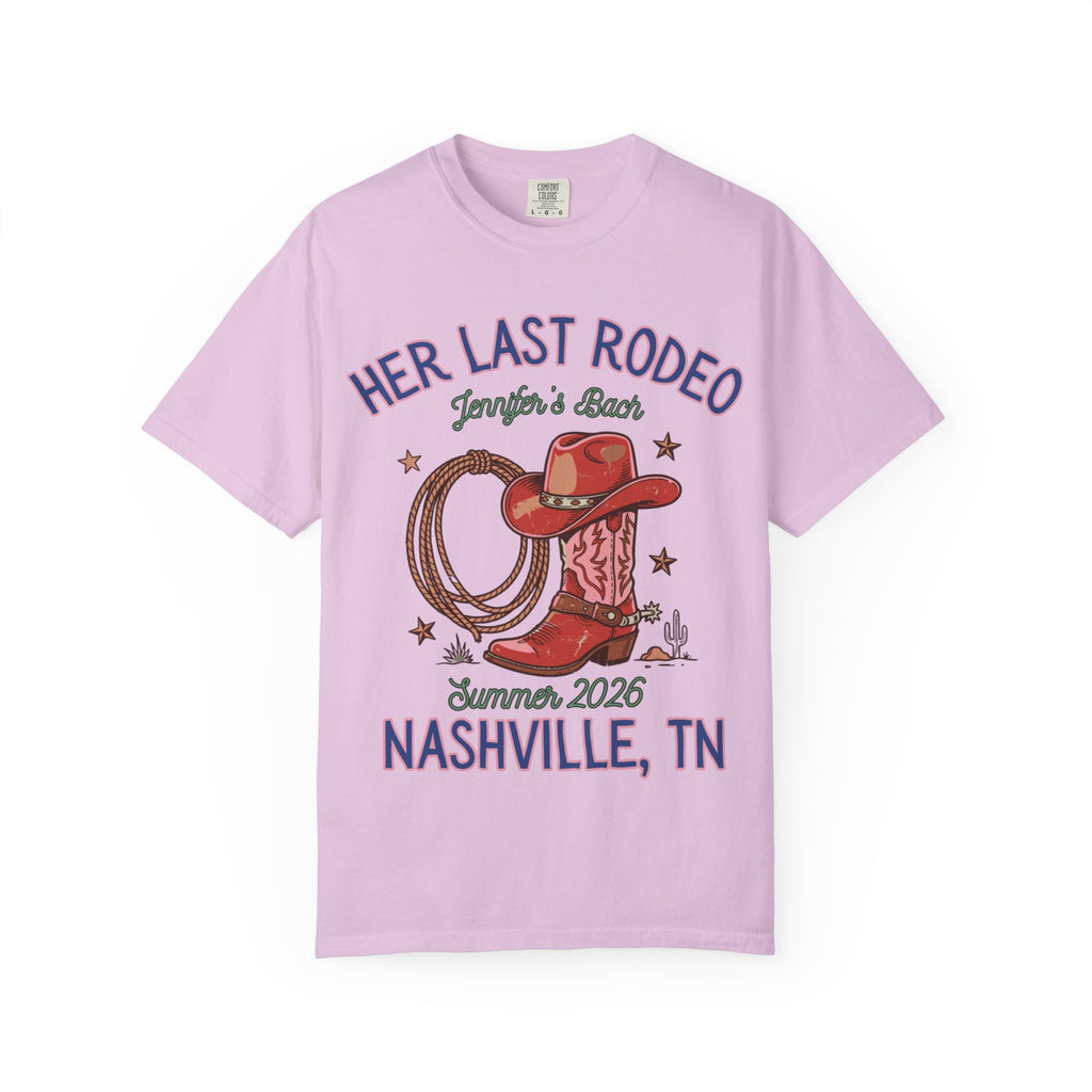 Pink t-shirt with "Her Last Rodeo" text, cowboy boot, hat, and rope.