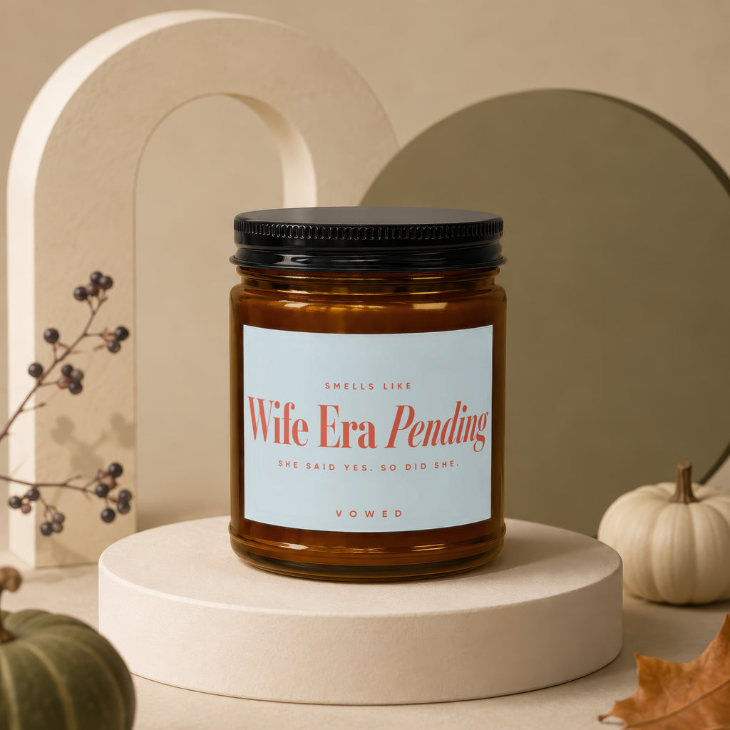 Candle with black lid, label reads "Wife Era Pending She Said Yes. So Did She. Vowed"