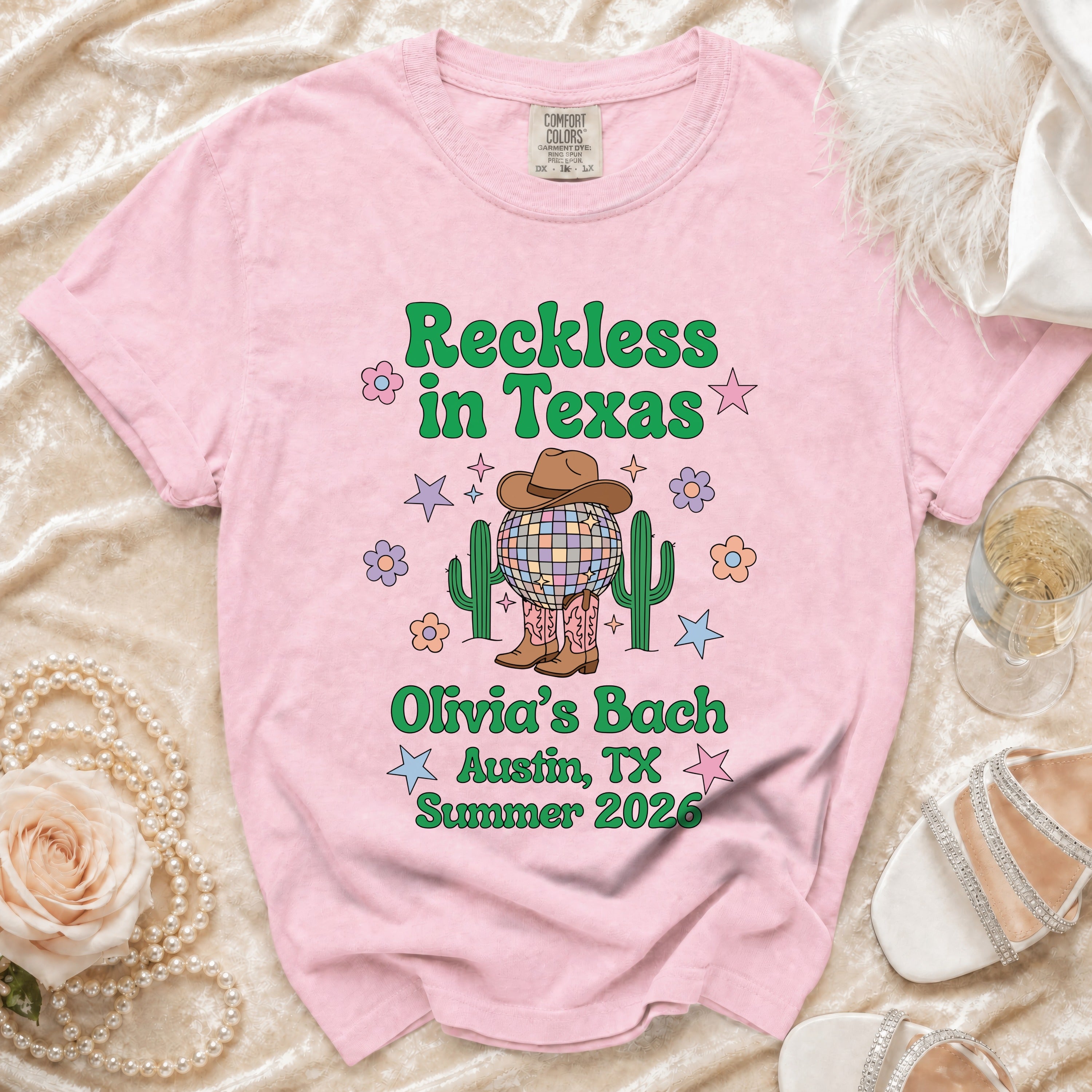 Pink t-shirt with "Reckless in Texas" and "Olivia's Bach Austin, TX Summer 2026".