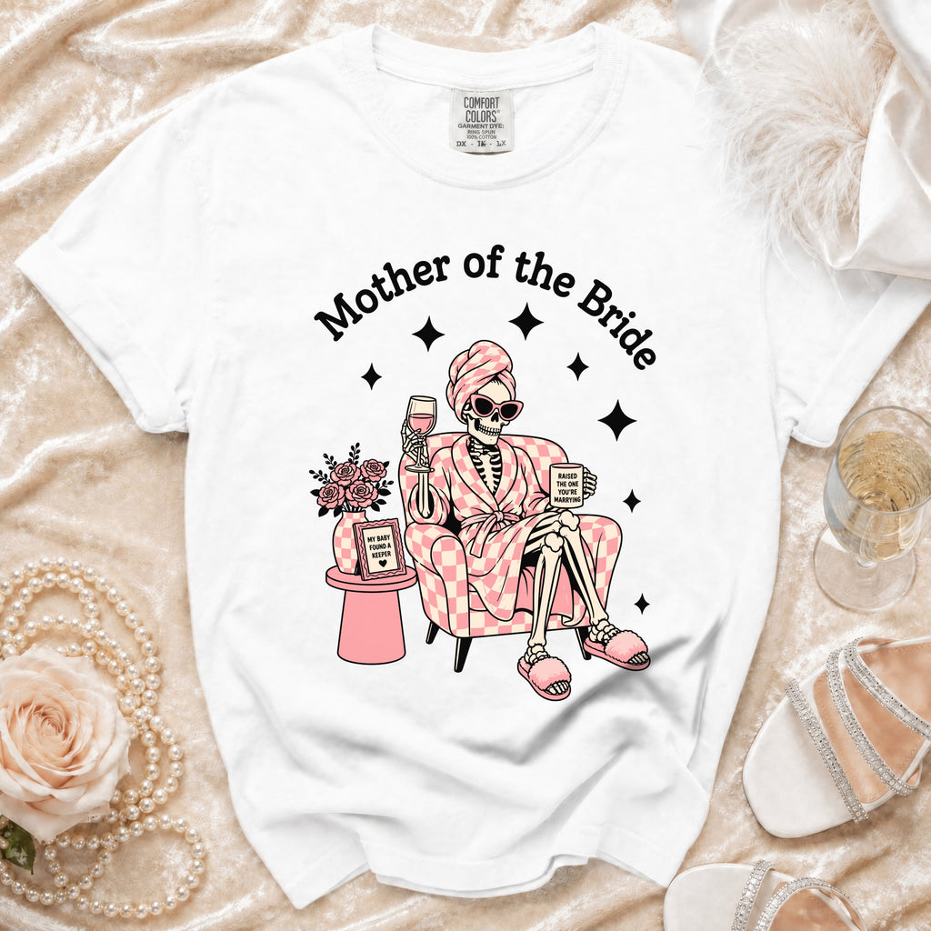 White t-shirt with "Mother of the Bride" graphic of a skeleton relaxing.