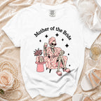 White t-shirt with "Mother of the Bride" graphic of a skeleton relaxing.