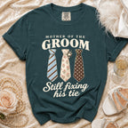 Teal t-shirt with "Mother of the Groom Still fixing his tie" text and three ties.