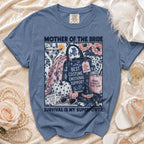 Blue t-shirt with "Mother of the Bride" text and graphic elements.