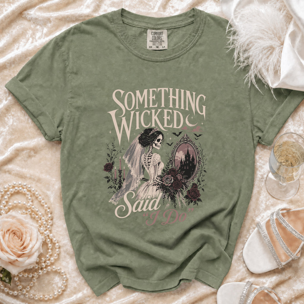 Sage green t-shirt with skeleton bride graphic saying "Something wicked said I do."