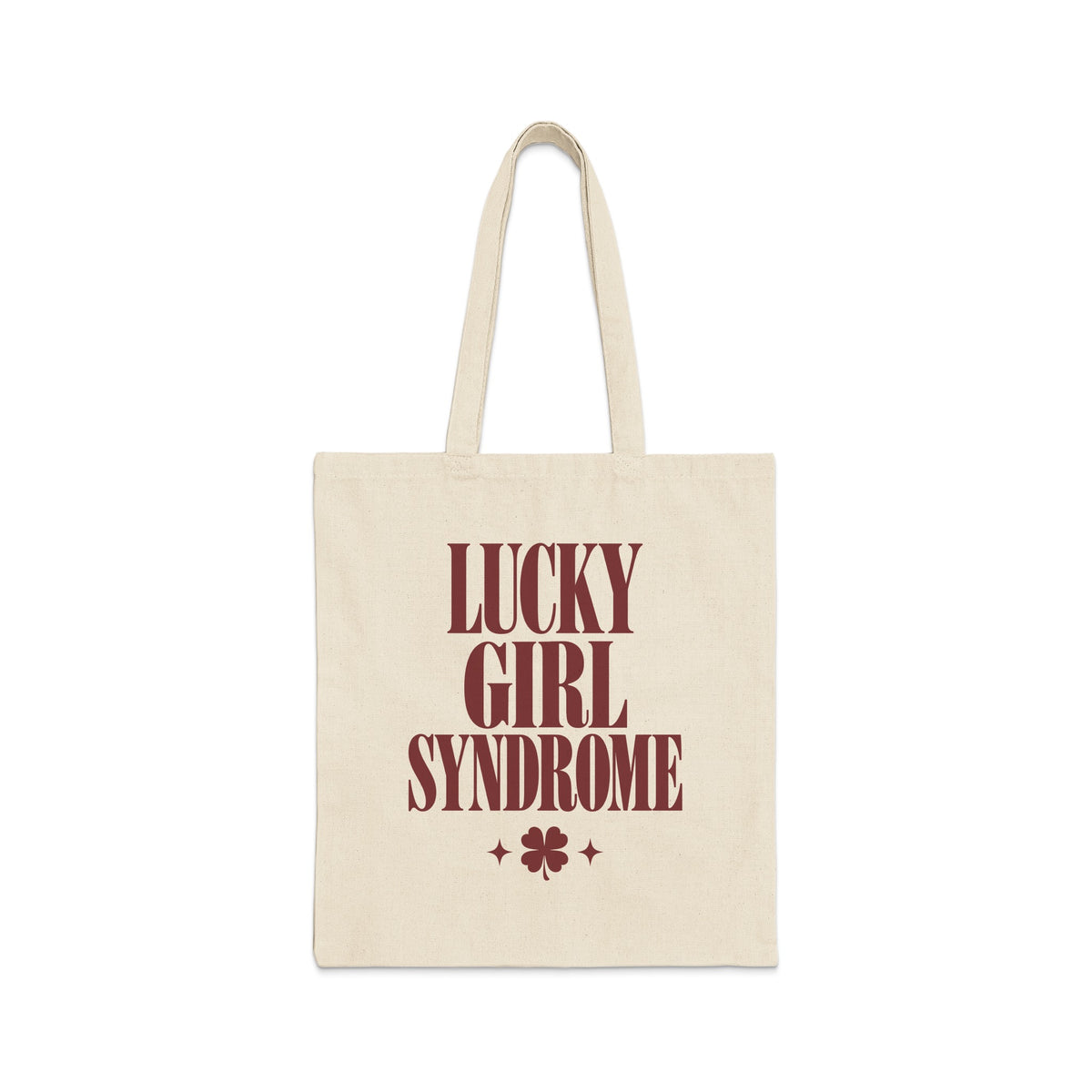 A natural canvas tote bag printed with maroon text reading Lucky Girl Syndrome above a four-leaf clover.