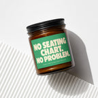 Amber jar candle with green label reading "NO SEATING CHART. NO PROBLEM."
