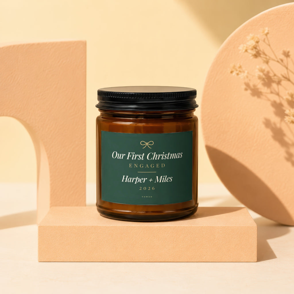 Brown glass candle with "Our First Christmas Engaged Harper + Miles 2026" text.