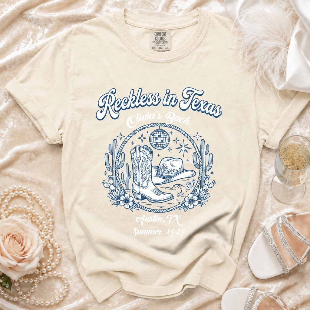 Reckless in Texas graphic tee with cowboy boots, hat, disco ball, and Austin, TX.