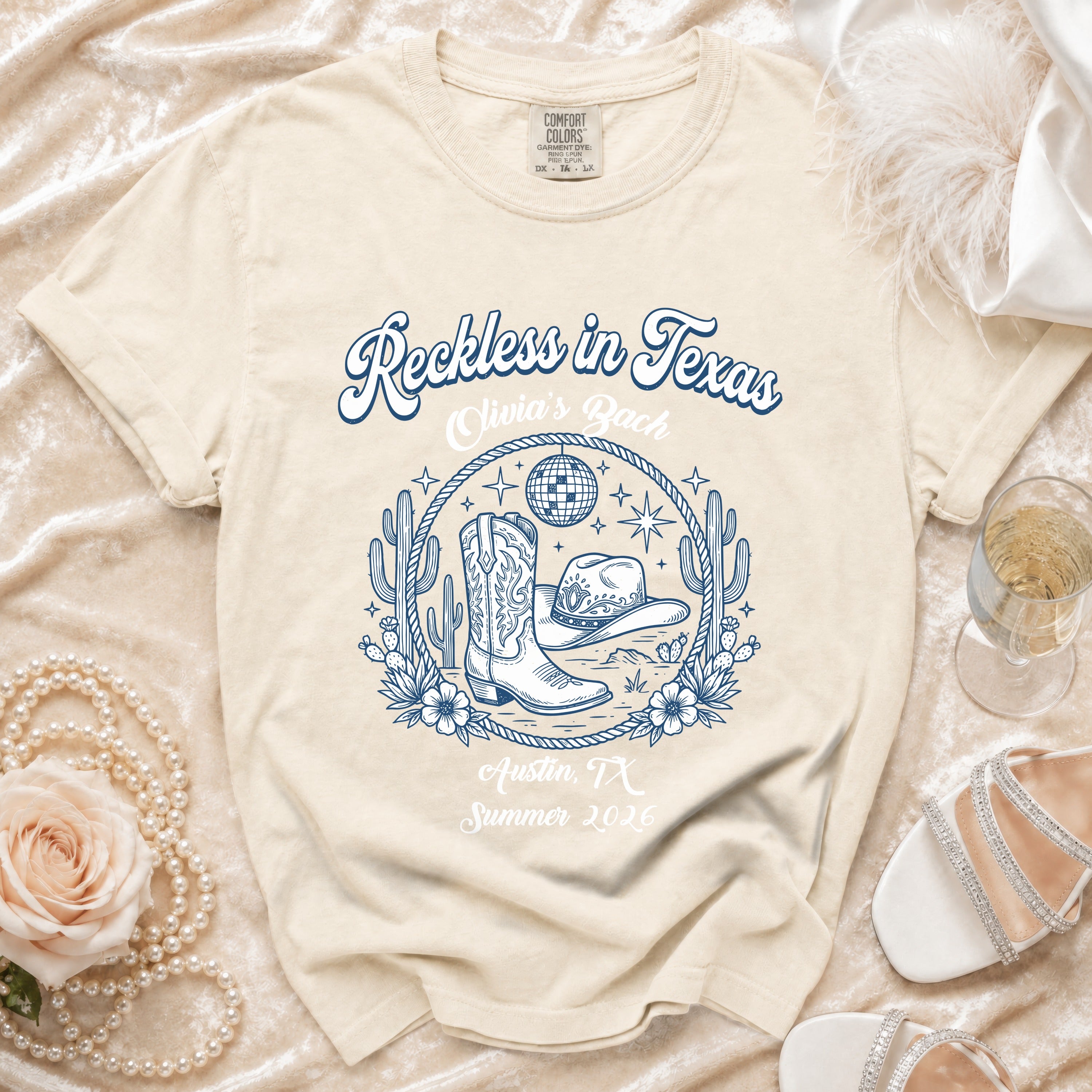 Reckless in Texas graphic tee with cowboy boots, hat, disco ball, and Austin, TX.