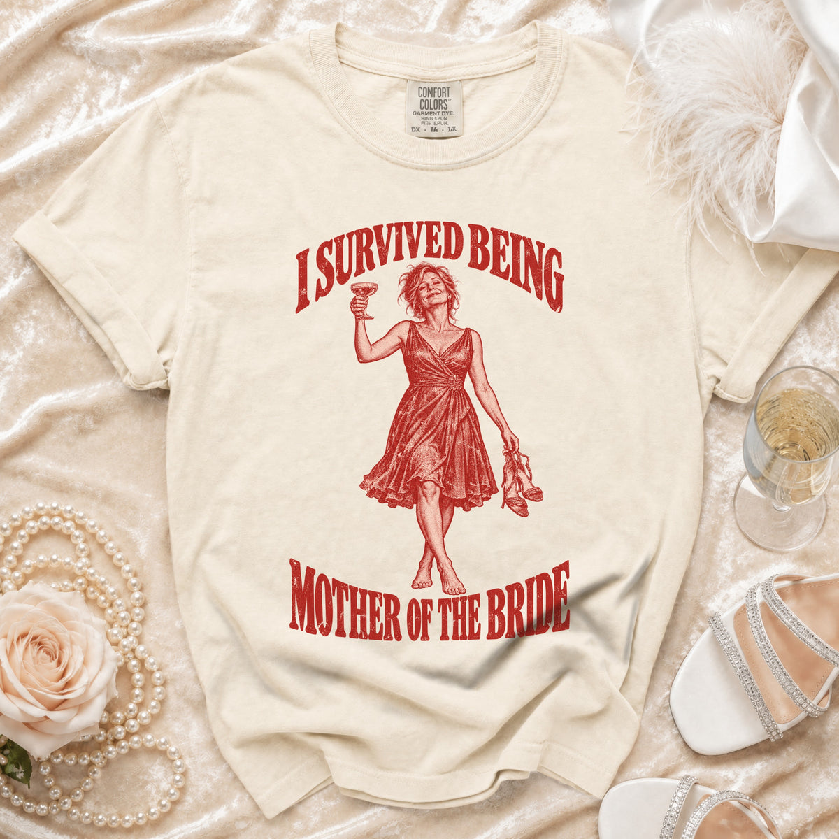 Cream t-shirt with "I survived being Mother of the Bride" text and graphic.