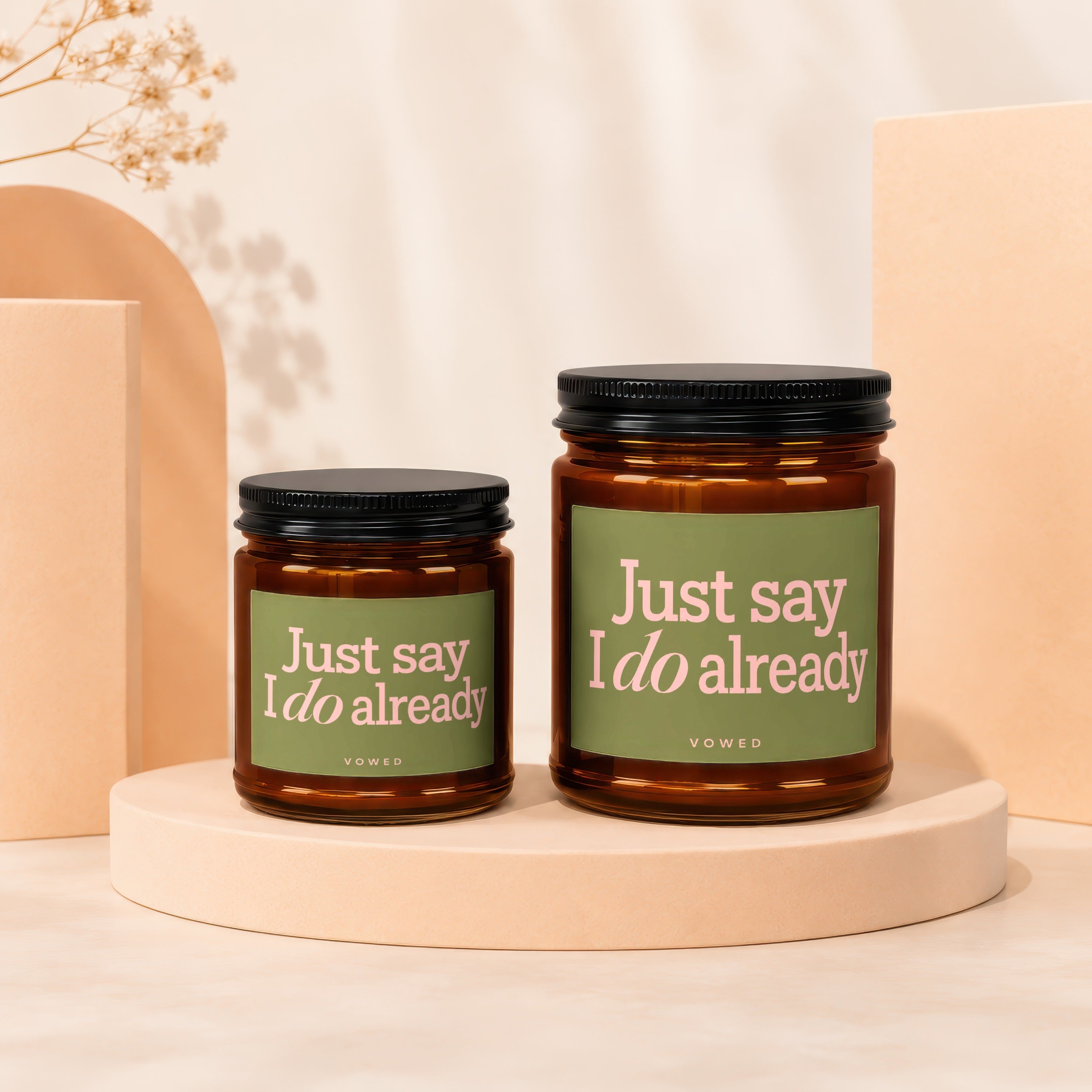 Two amber glass candles with green labels reading "Just say I do already".