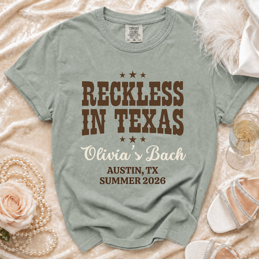 T-shirt with "Reckless in Texas," "Olivia's Bach," and location/date.