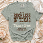 T-shirt with "Reckless in Texas," "Olivia's Bach," and location/date.