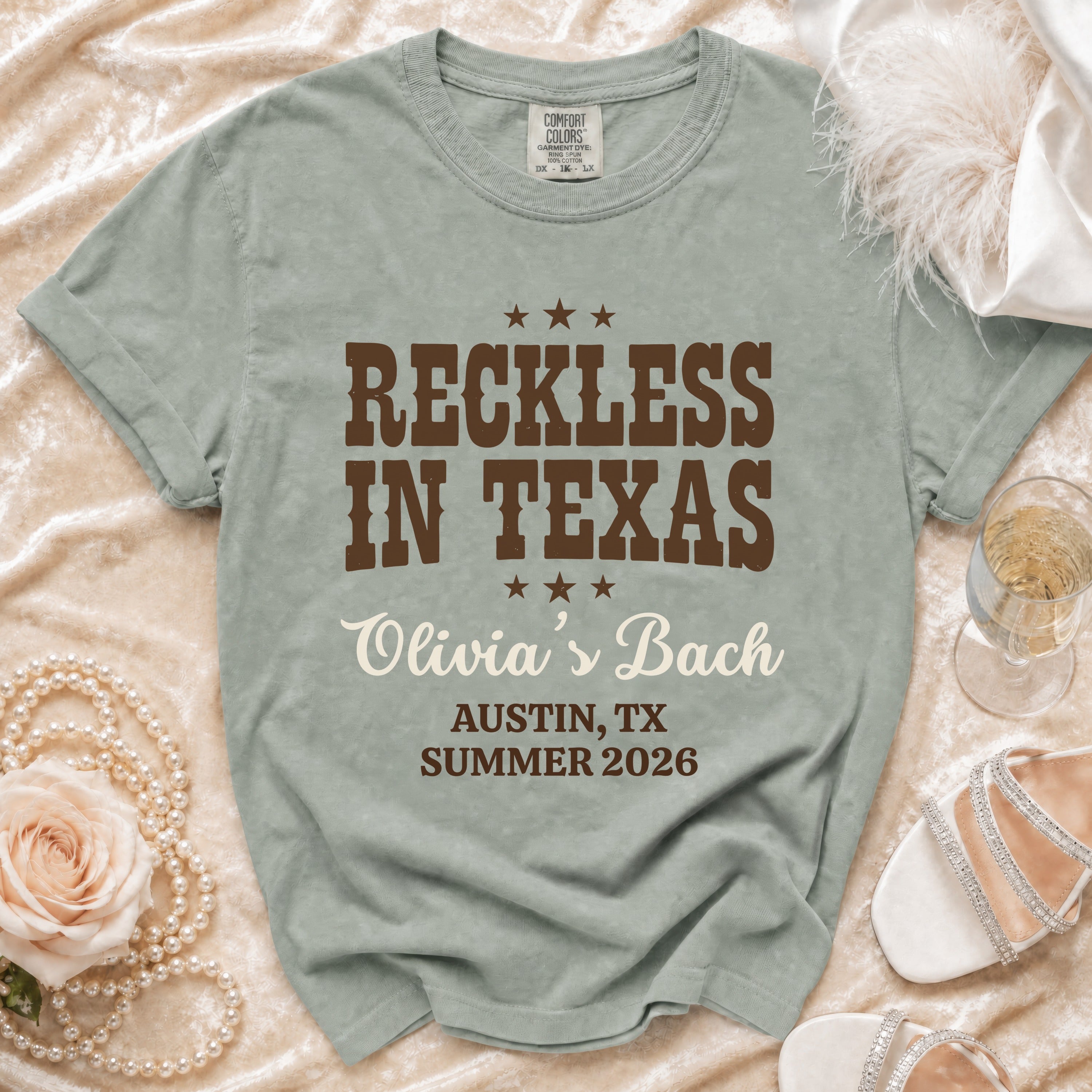 T-shirt with "Reckless in Texas," "Olivia's Bach," and location/date.