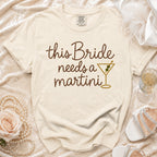 Light cream t-shirt with "this Bride needs a martini" text and martini glass graphic.