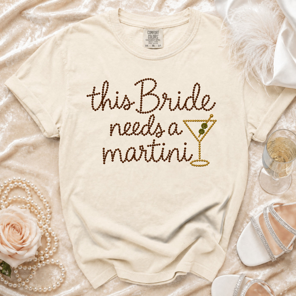 Light cream t-shirt with "this Bride needs a martini" text and martini glass graphic.