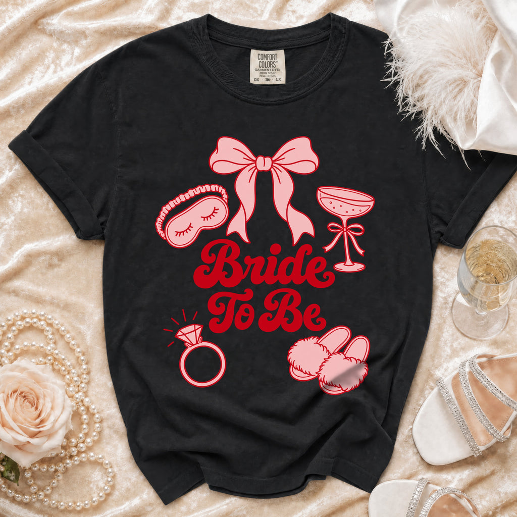 Black t-shirt with "Bride To Be" text and bridal icons.