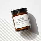 Amber candle in a glass jar with a black lid, reading "smells like a question only you can answer. MY MAID OF HONOR?"