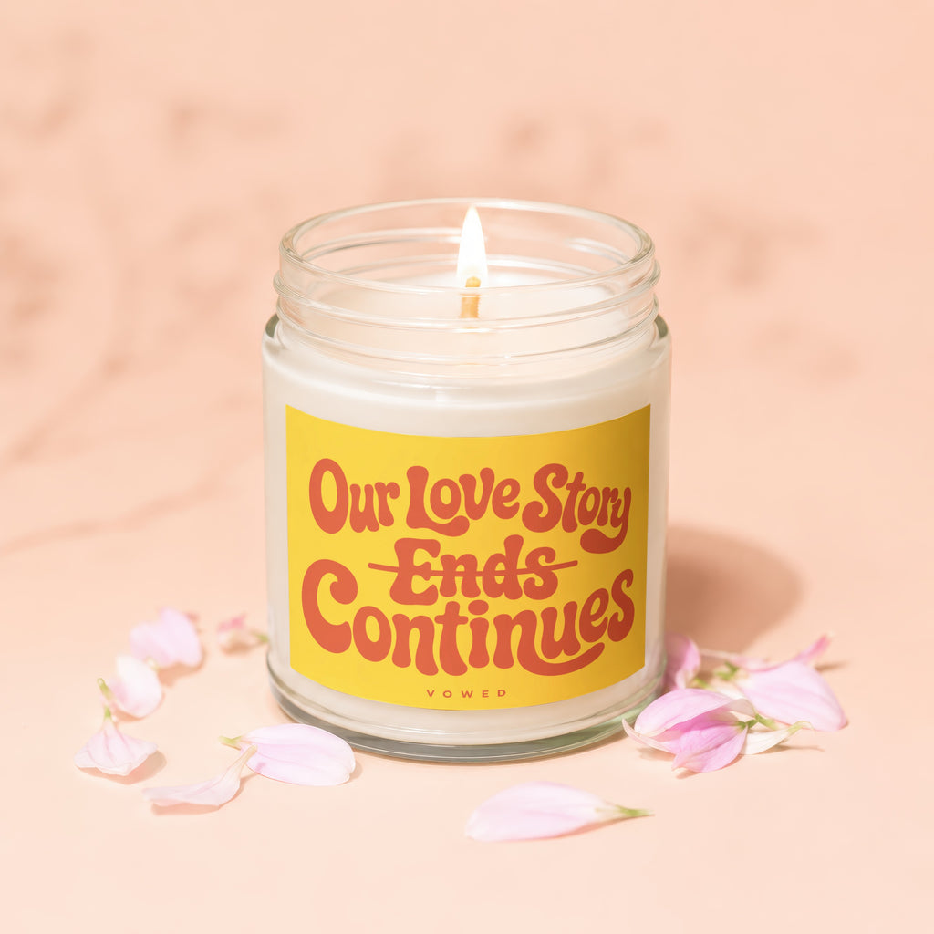 Candle with yellow label: "Our Love Story Ends Continues" and "VOWED".