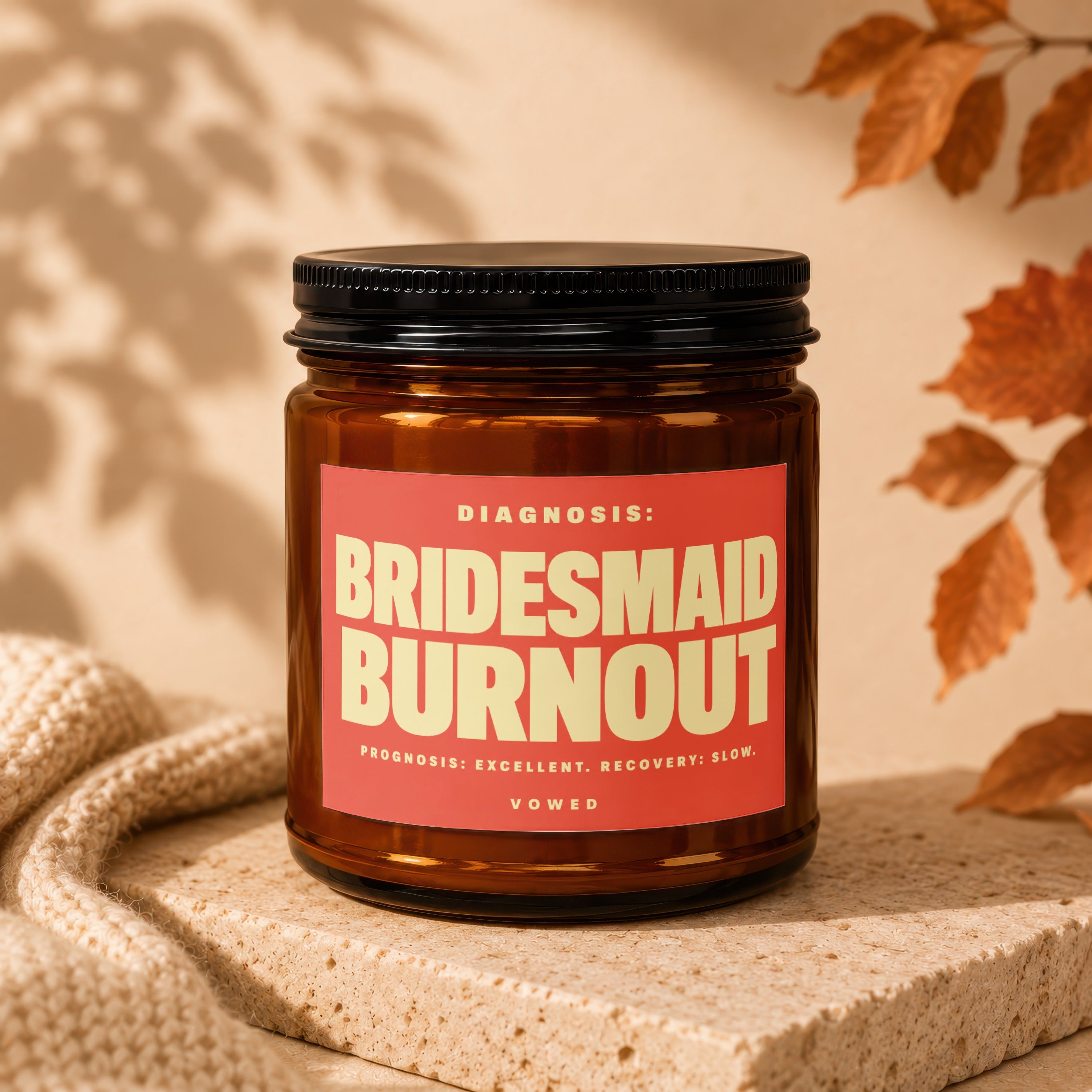 Amber candle with 'Bridesmaid Burnout' text on red label.