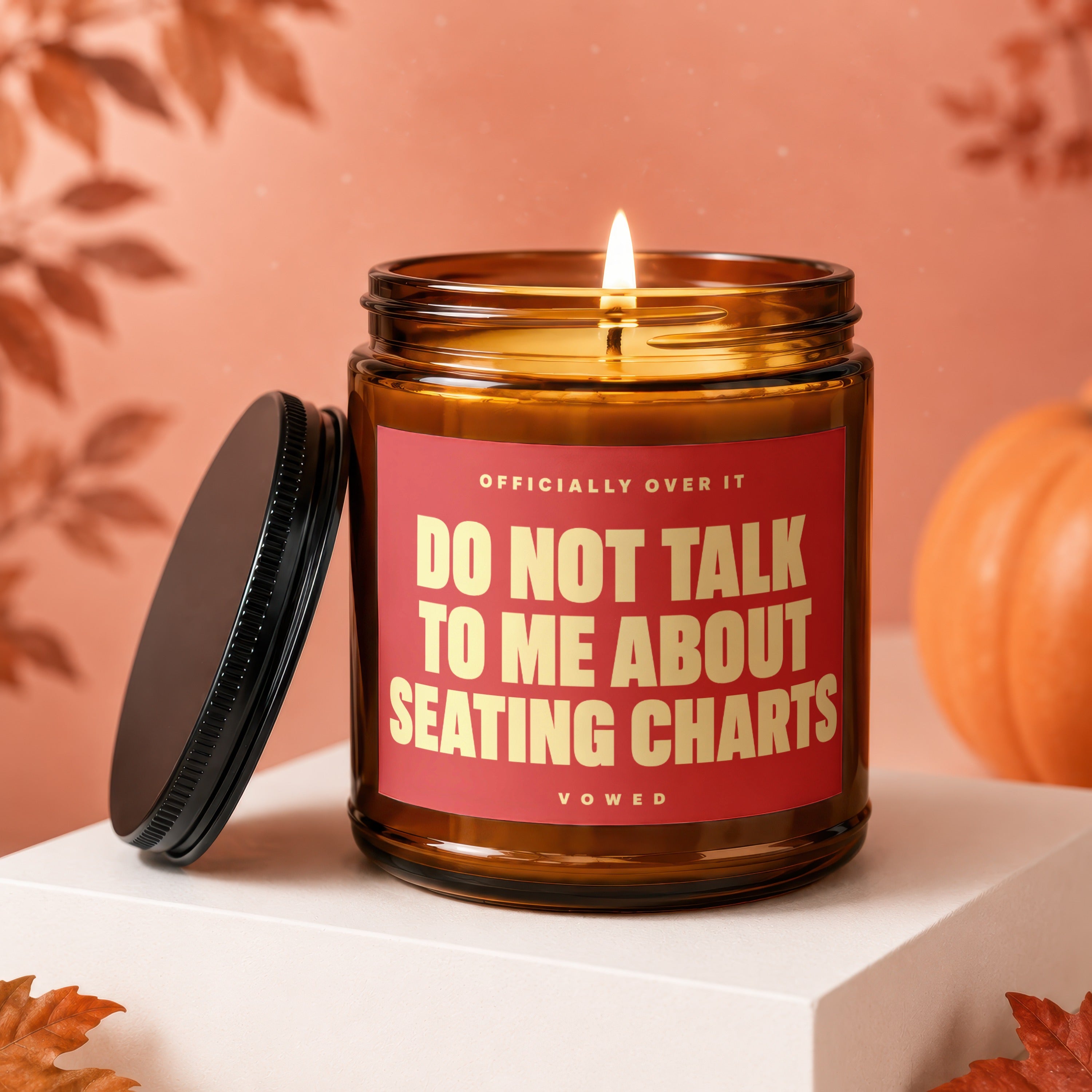 Amber candle with red label reading "DO NOT TALK TO ME ABOUT SEATING CHARTS"