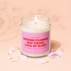 Candle with pink label reading "Caution: Wedding planning may cause loss of sleep. Bridesmaid support included."