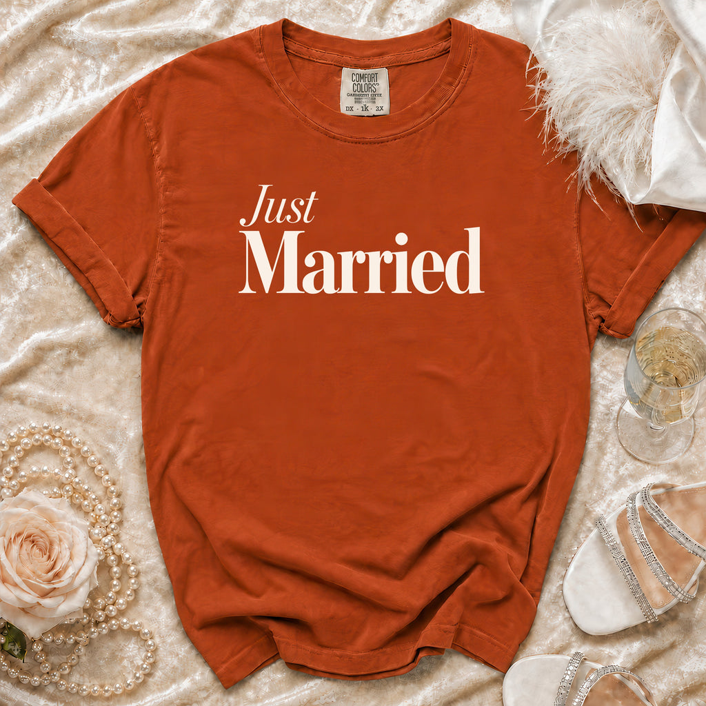 Orange t-shirt with "Just Married" in white text, surrounded by pearls and a rose.