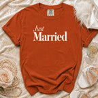 Orange t-shirt with "Just Married" in white text, surrounded by pearls and a rose.