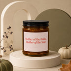 Amber jar candle with label reading "Mother of the Bride, Mother of the Year."