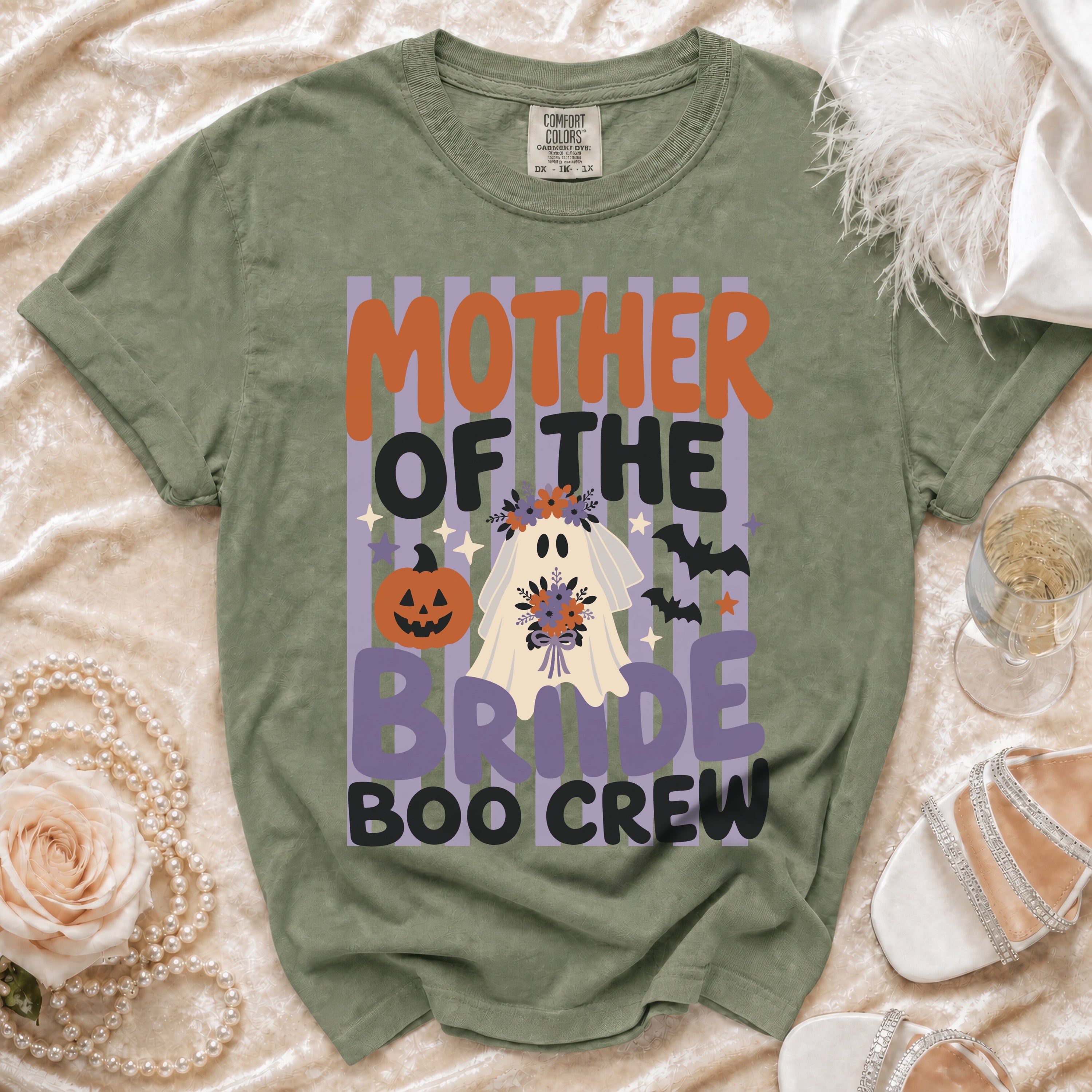 Olive green t-shirt with a Halloween graphic featuring the text "Mother of the Bride Boo Crew".