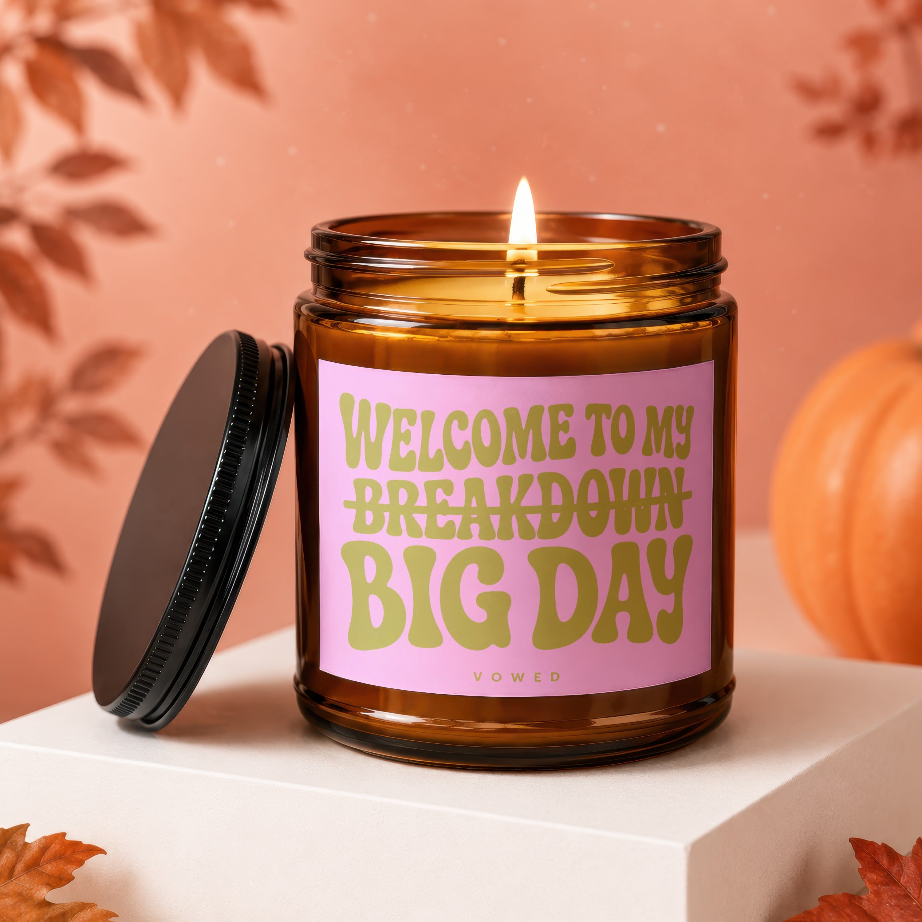 Amber jar candle with pink label reading "Welcome to my Breakdown Big Day."