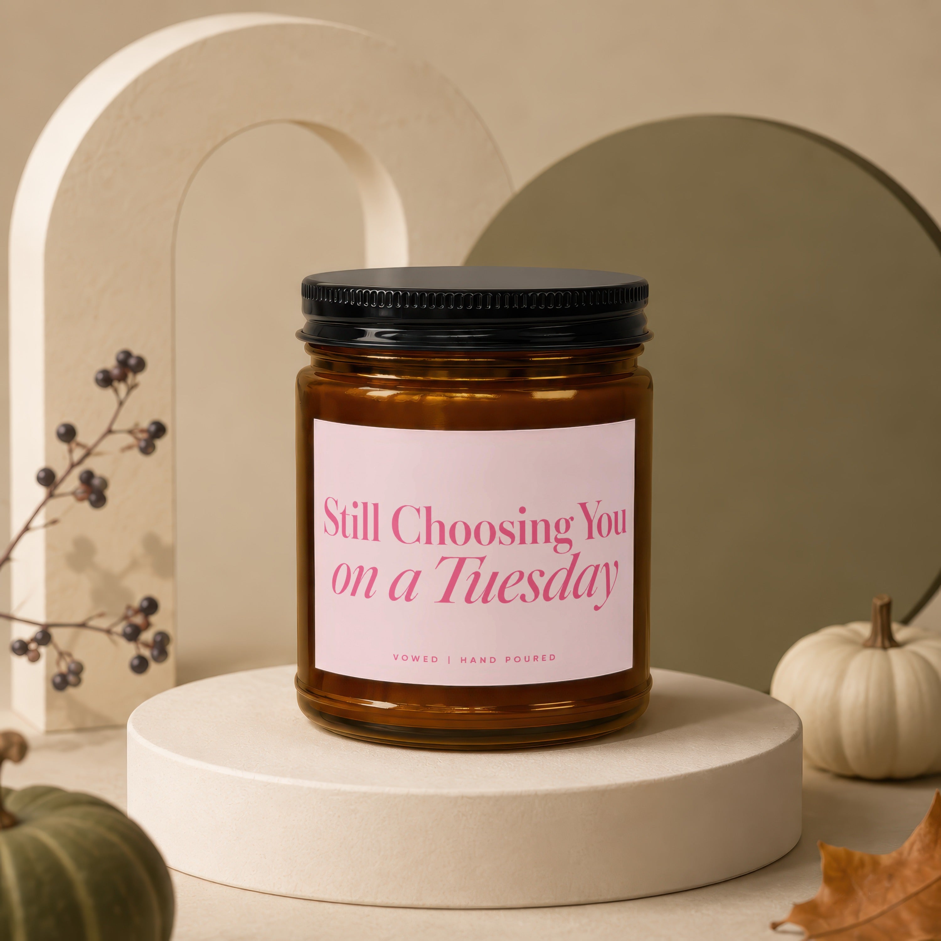 Glass candle with pink label reading "Still Choosing You on a Tuesday Vowed | Hand Poured".