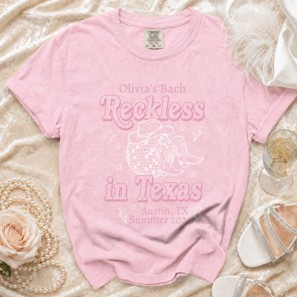 Pink t-shirt with "Olivia's Bach Reckless in Texas Austin, TX Summer 2026" graphic.