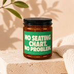 Glass jar candle with green label reading "NO SEATING CHART. NO PROBLEM."