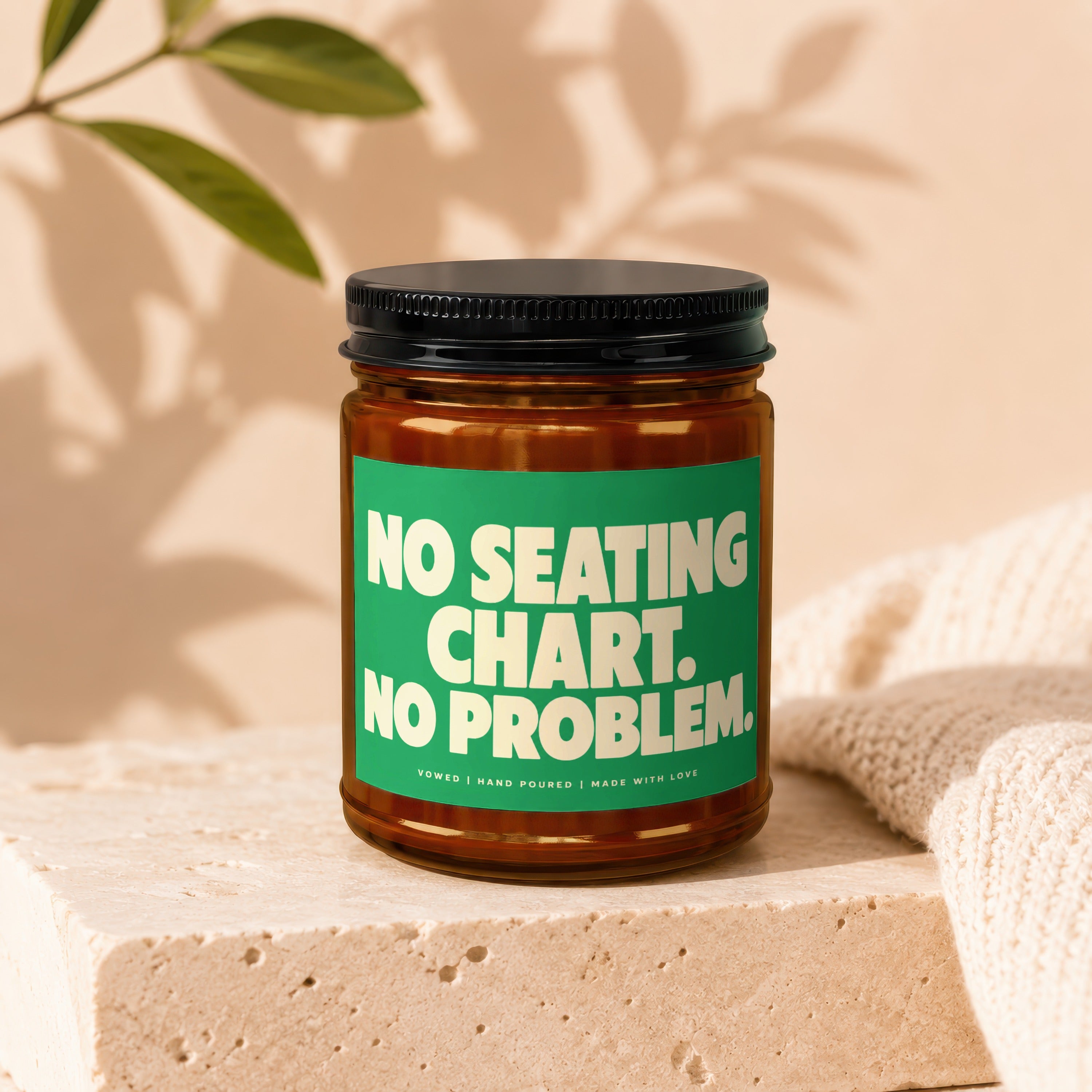 Glass jar candle with green label reading "NO SEATING CHART. NO PROBLEM."